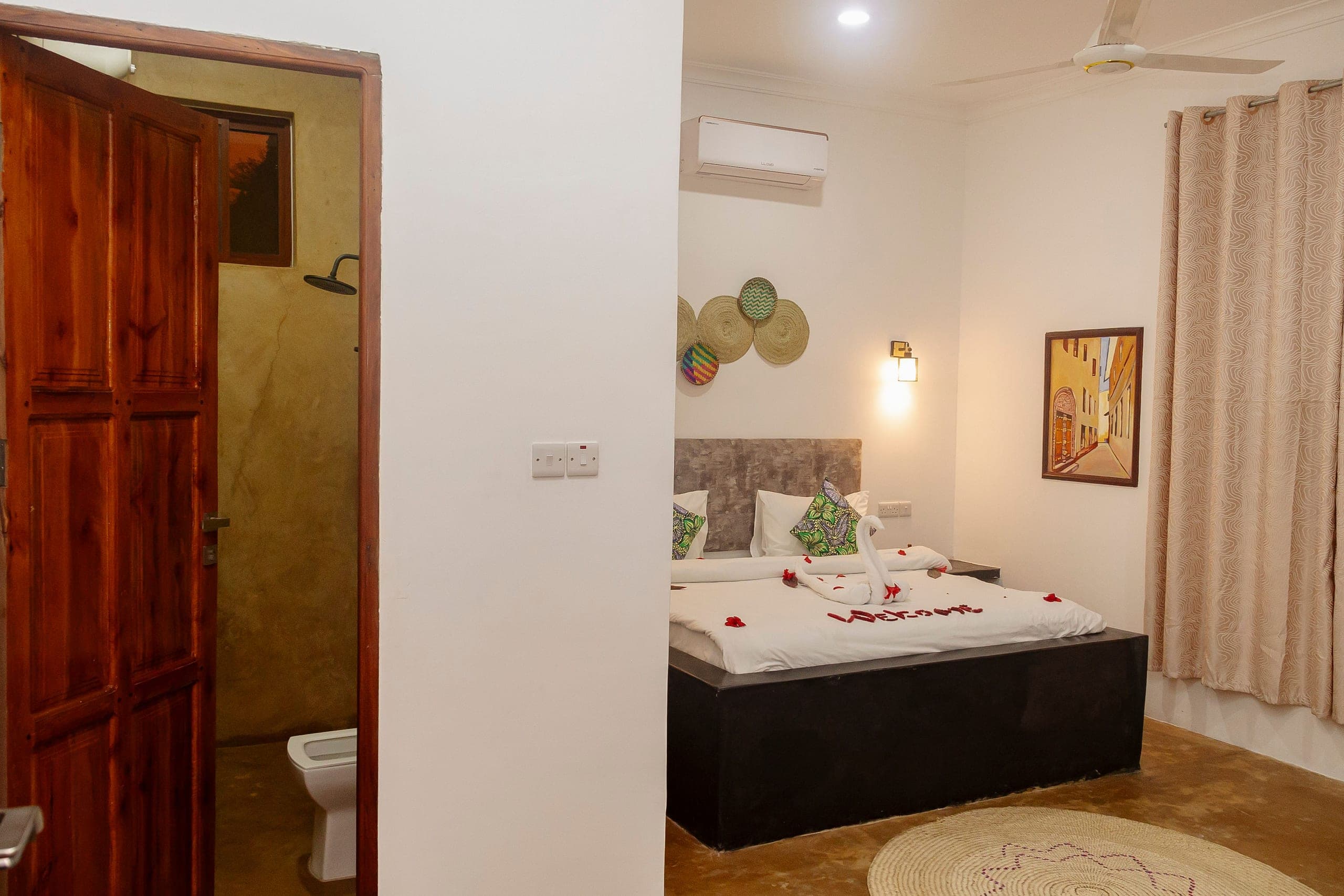Bedroom with the door to its private bathroom standing open