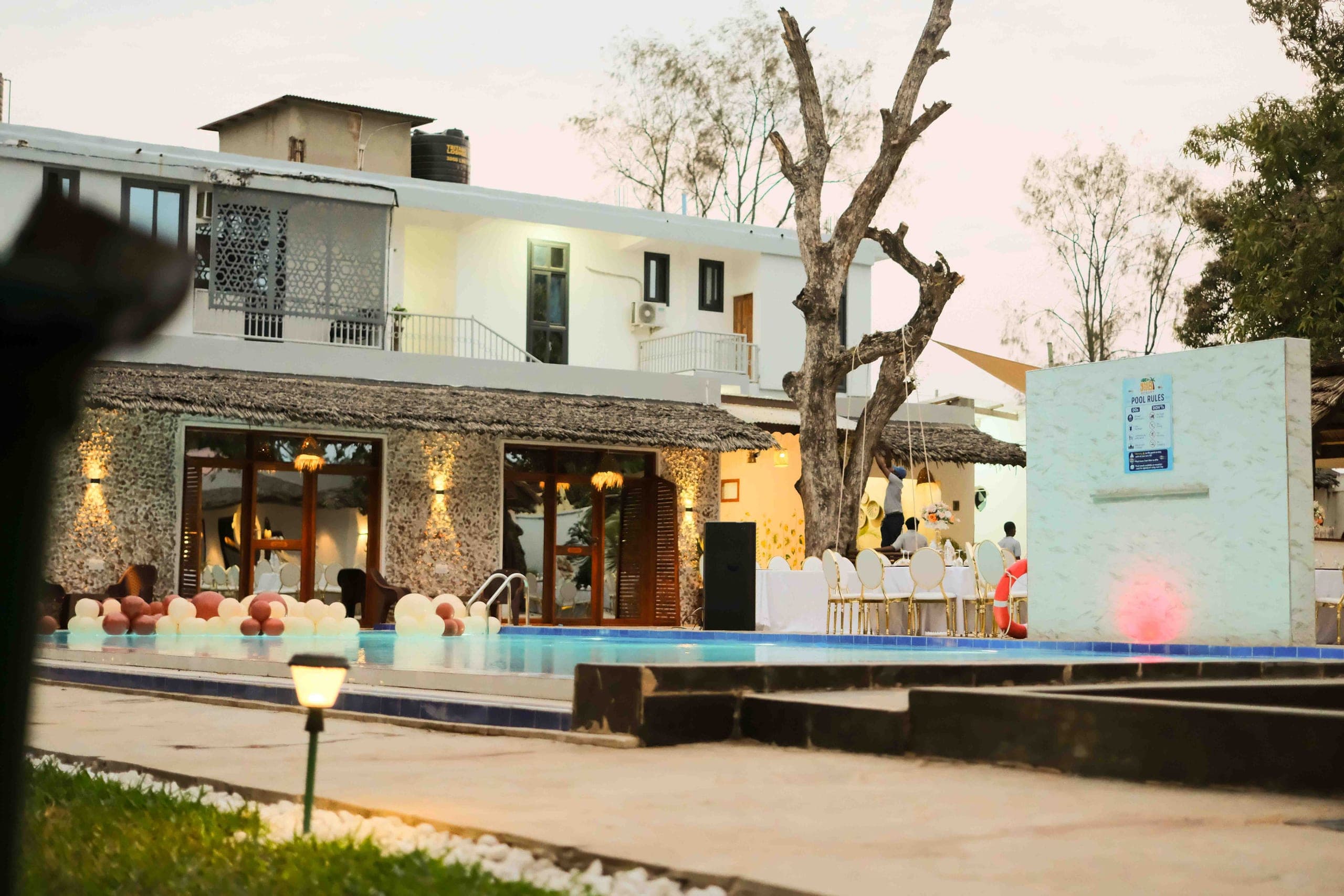 Poolside gathering as evening light settles over the resort