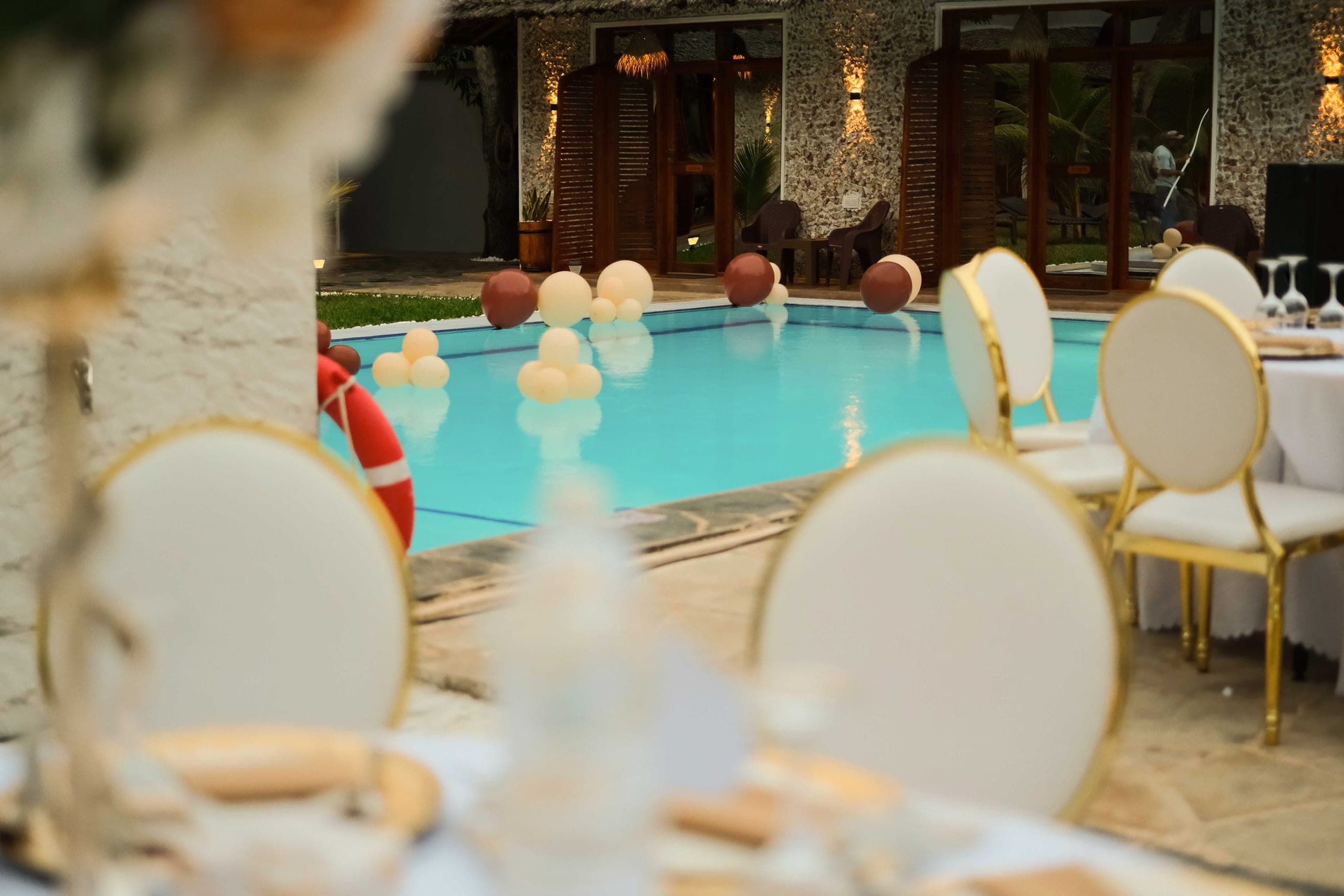 Tables and decorations arranged beside the pool