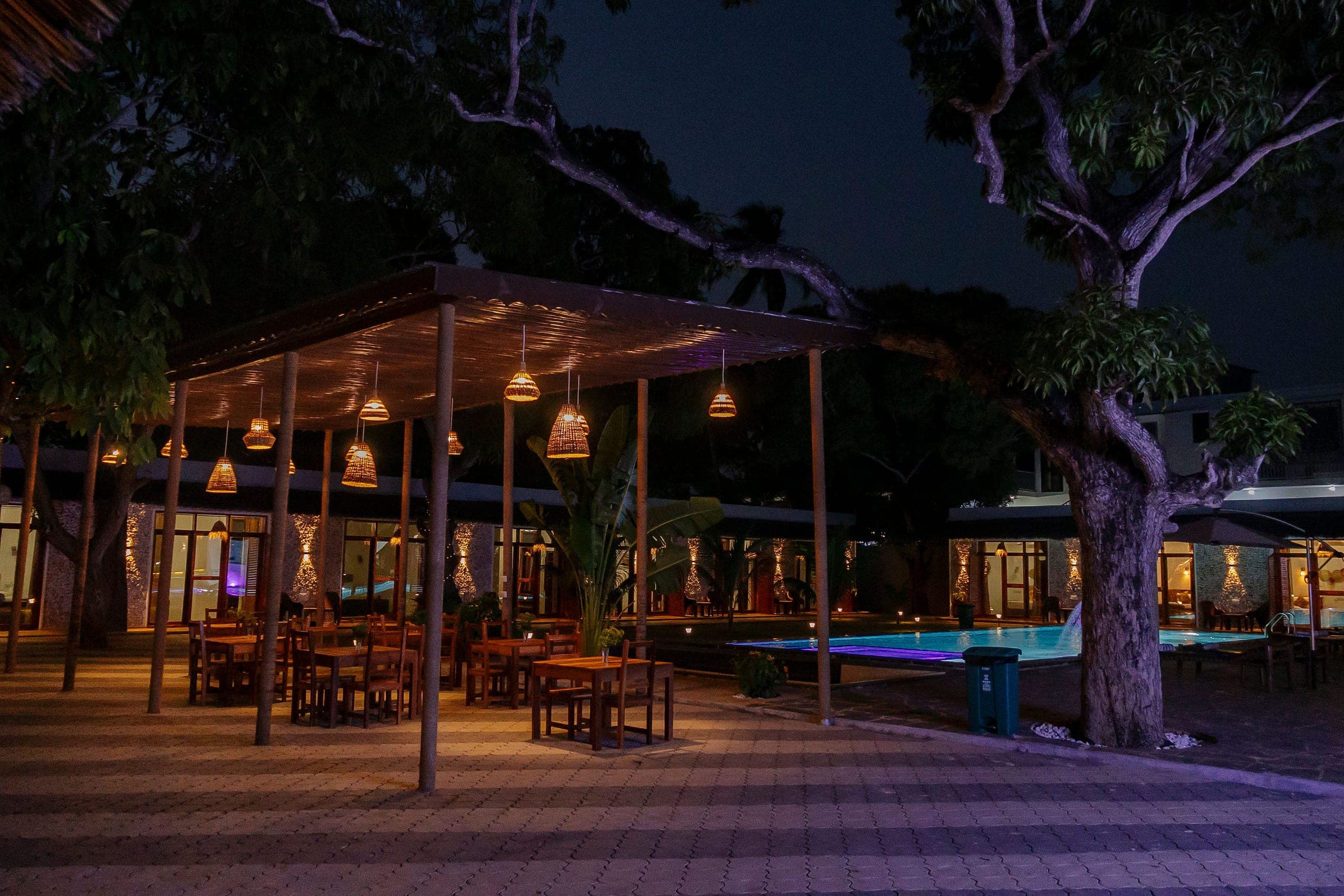 Warm lights around the open-air restaurant at night