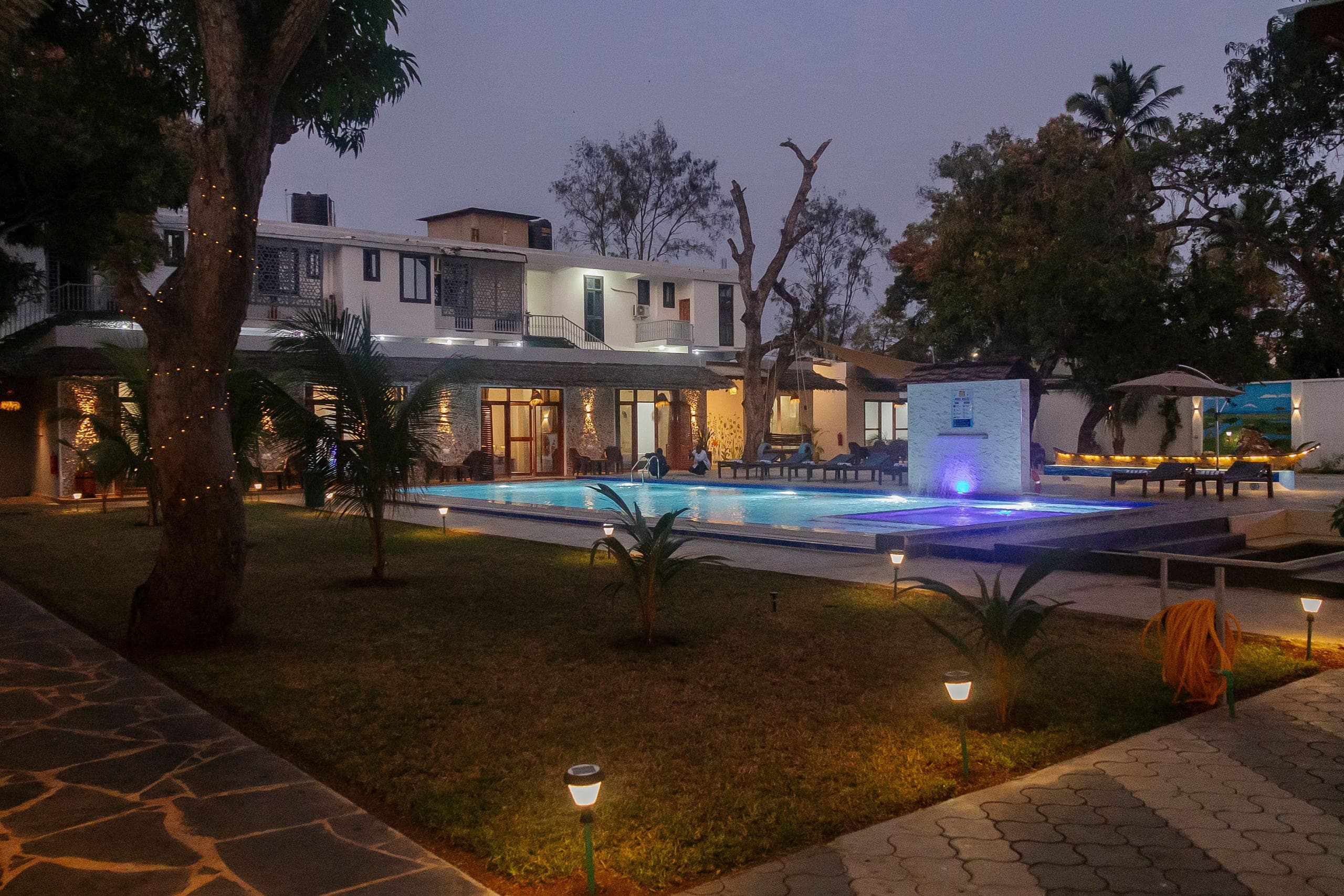 JoyB Resort pool and gardens glowing at twilight