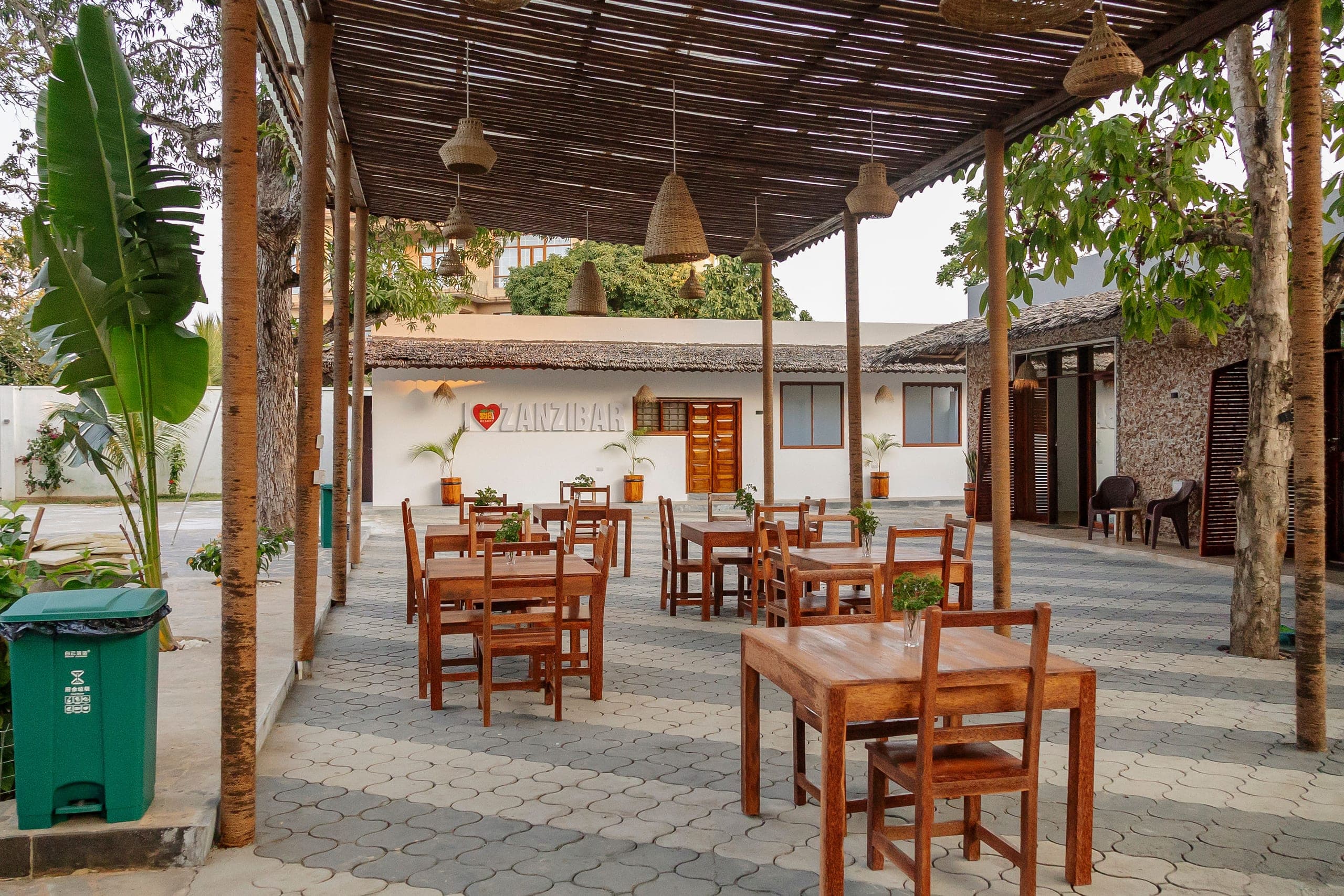Restaurant terrace with tables among the garden trees