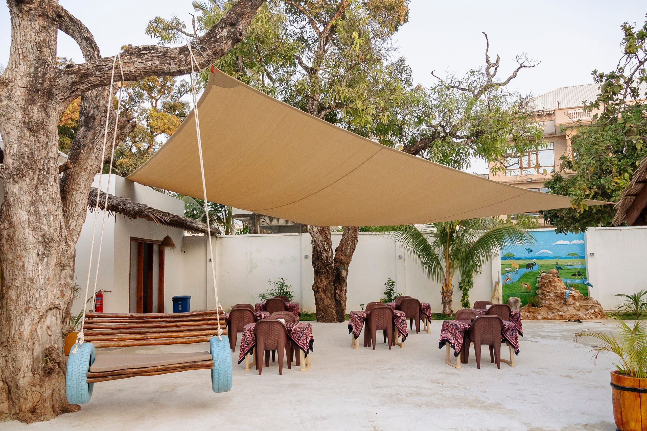 Outdoor lounge seating beneath a shade sail